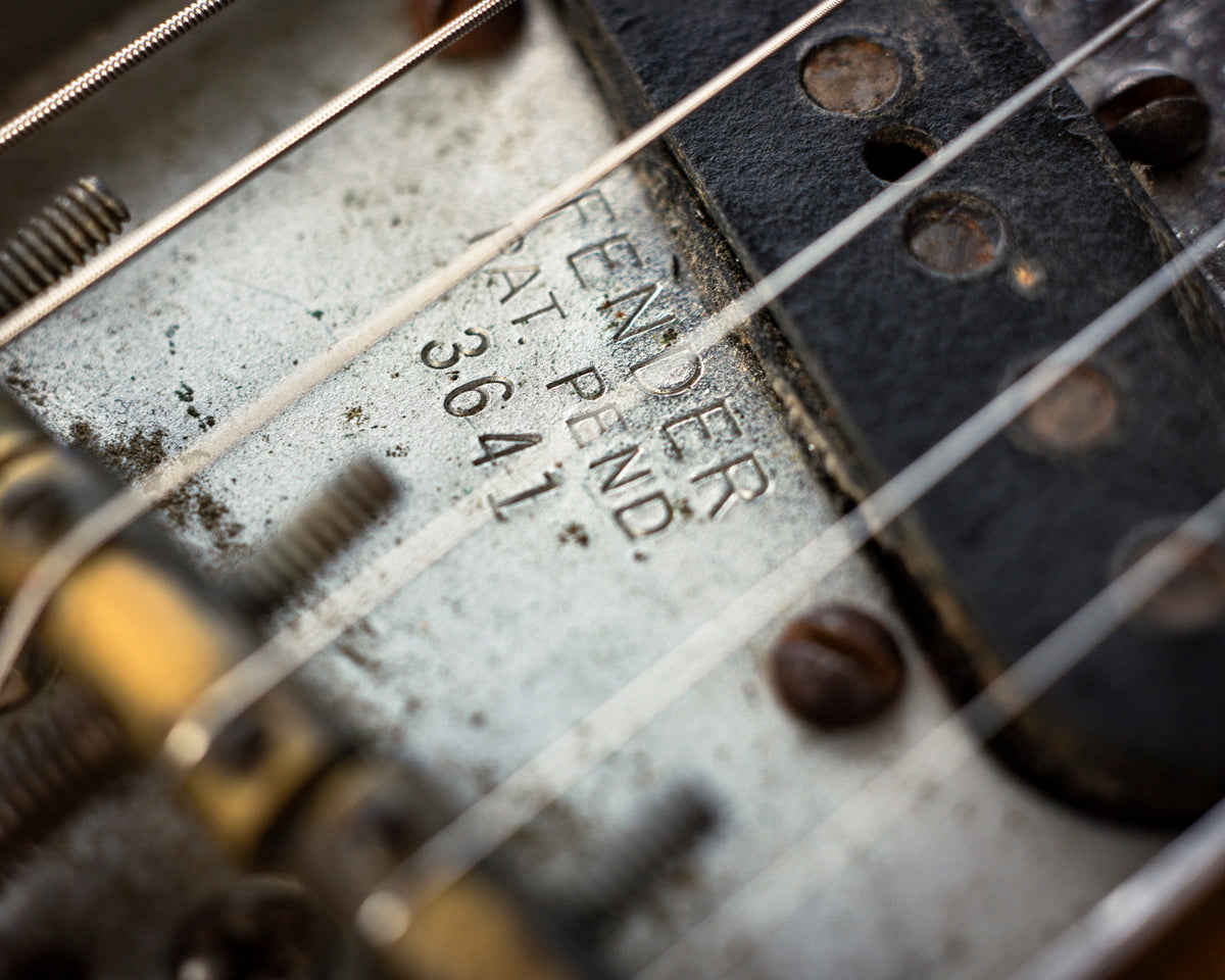 Close-up of vintage Fender telecaster pickup and saddle screws. 