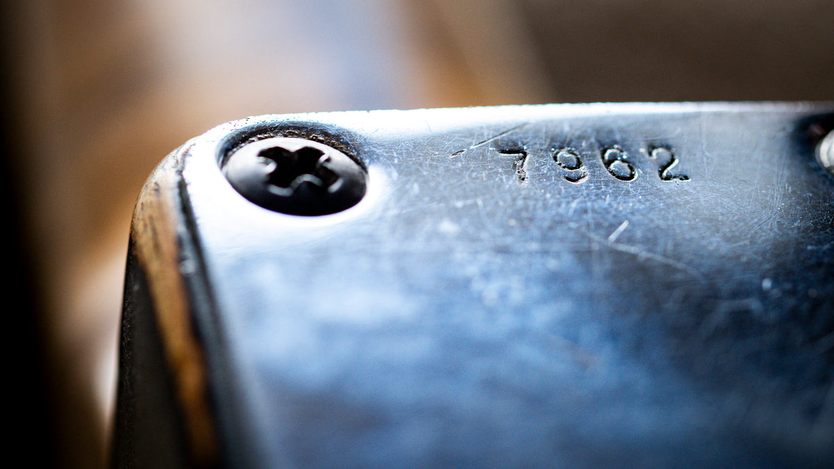 Close-up of guitar serial number and ingtage phillips screw