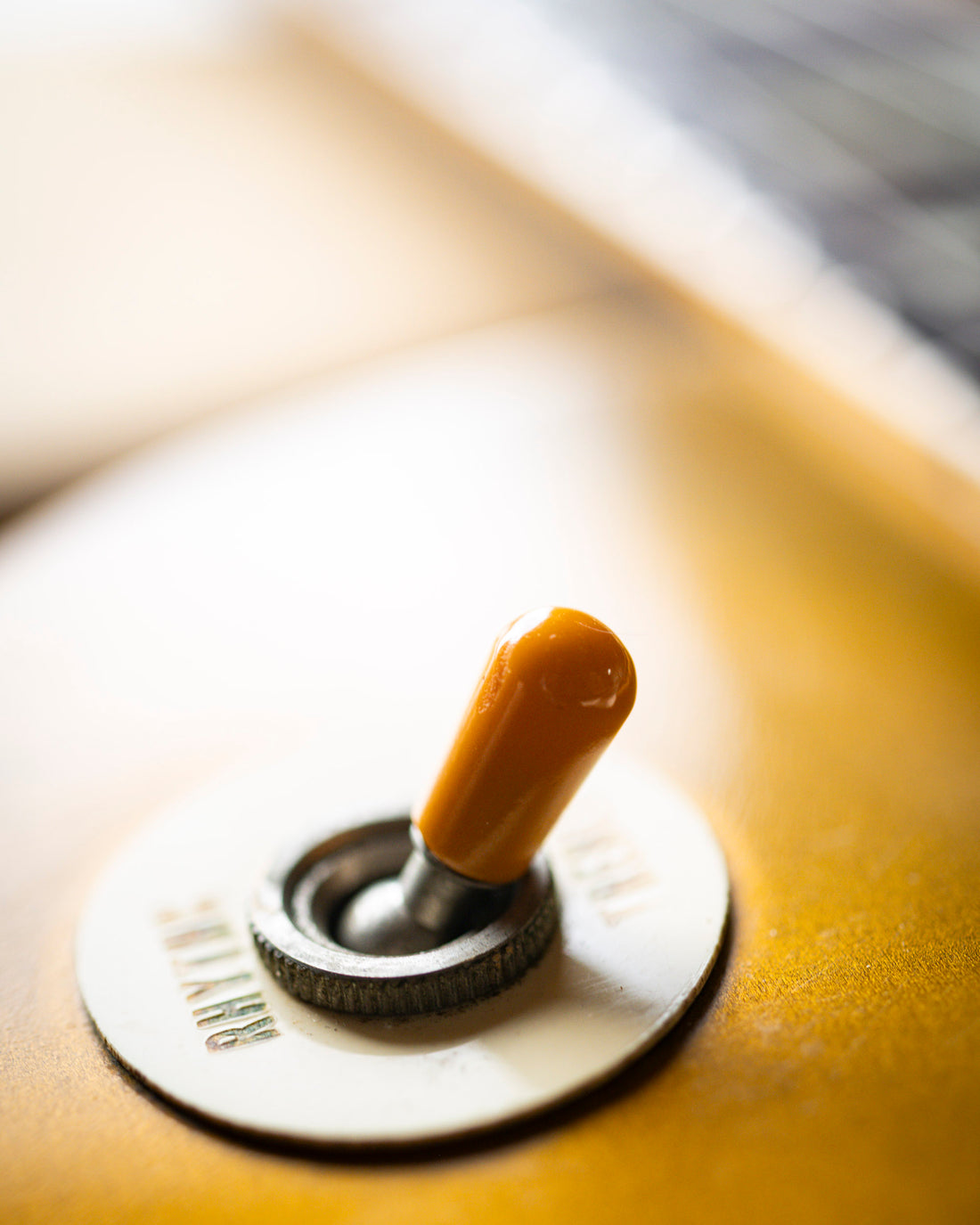Close-up of a vintage Gibson Les Paul gold top pickup selector switch. 