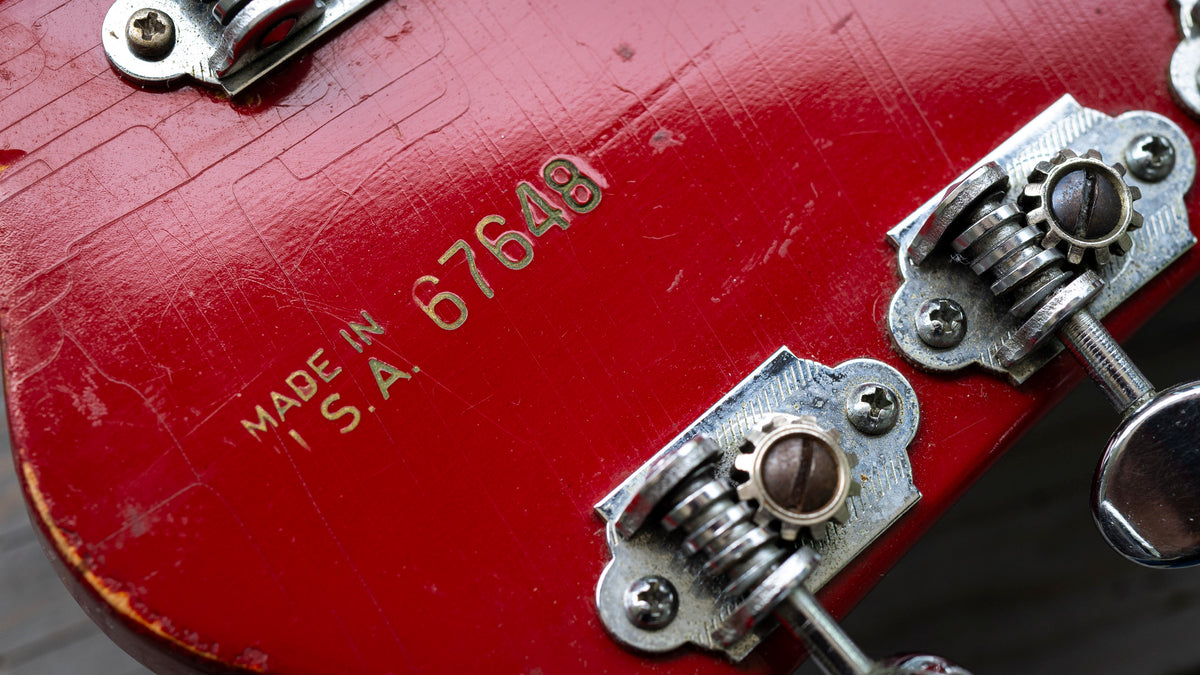 Close-up of a red Gretsch Tennessean from 1967 (Baldwin Era) guitar with tuning pegs and serial number '67649'.