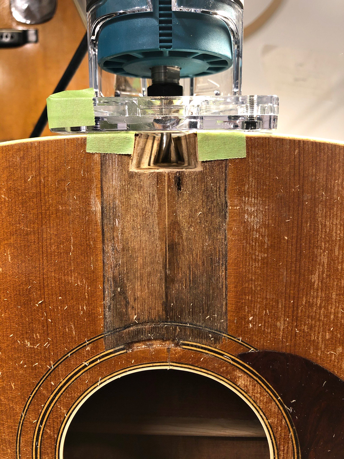 Routing the dovetail of a 1940's Regal guitar during X-brace conversion and neck set.